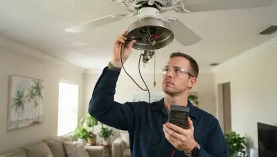 Electrician uses a multimeter to diagnose a ceiling fan switch in a Fort Lauderdale, FL home