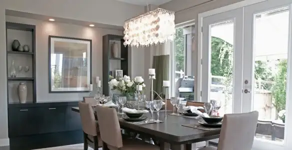 Elegant dining room chandelier installation above table in Fort Lauderdale, FL