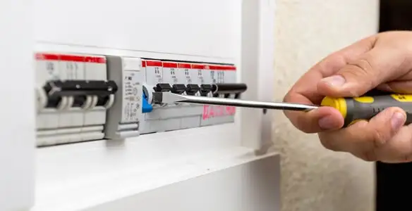 electrical panel upgrade service showing technician adjusting circuit breakers during system upgrade in Fort Lauderdale, FL