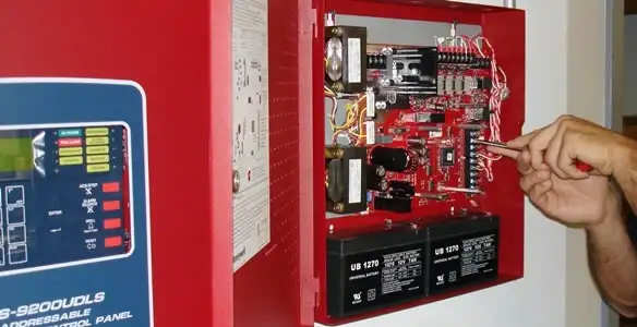 fire alarm installation service showing technician configuring fire alarm control panel in Fort Lauderdale, FL