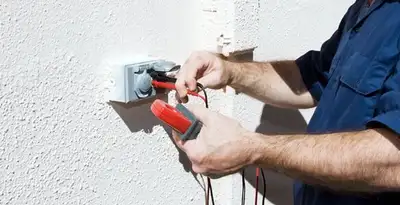 Electrician performing home electrical outlet and wiring inspection in Fort Lauderdale, FL