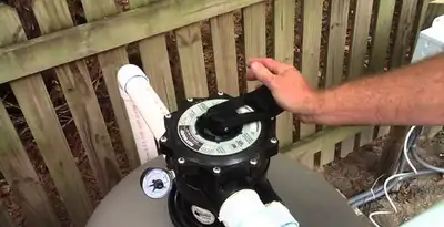 pool pumps service showing professional adjustment of pool pump control system in Fort Lauderdale, FL